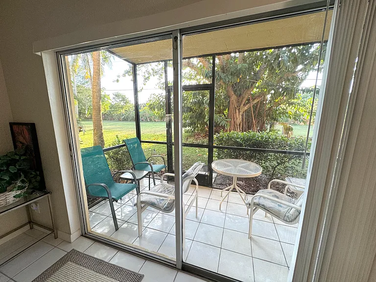 View of screen room / Florida room with furniture out to yard, El Rio canal and short walk from FAU