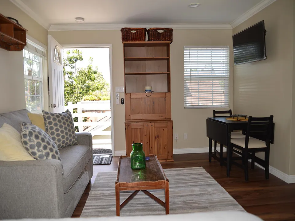 Main living room area with dining area on right, computer station with drop down shelf in middle.