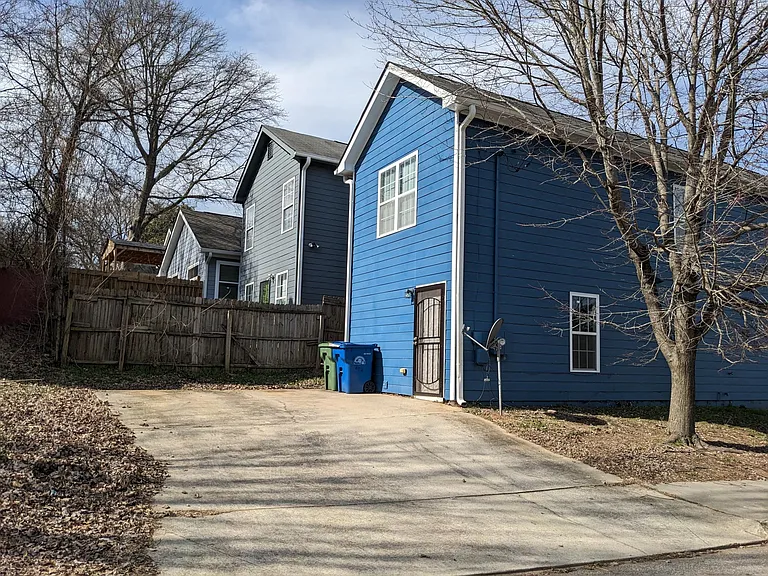 Back of home with offstreet parking