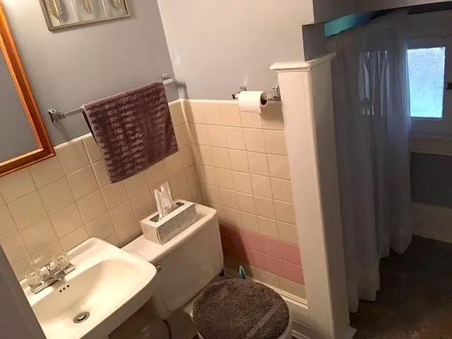 Half bathroom (for guests) off grand living/dining room. Includes closet/extra storage space.