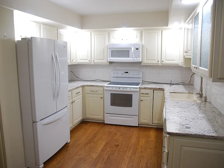 Large kitchen with granite countertops and newer appliances.
