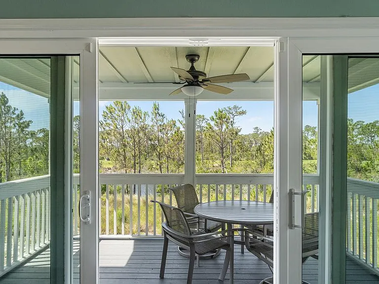 Balcony off of living room overlooking golf course and pond.
