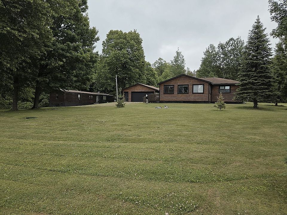View of 2 homes and garage