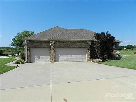 Attached 3 car finished garage.  Can also be used as a lovely party room for a buffet and tables.  This area of cement driveway is great for basketball, or can be transformed into a dance floor with rope lights and Tiki Torches.