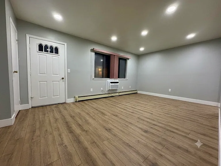 The living room includes brand new flooring and new ceiling lights.