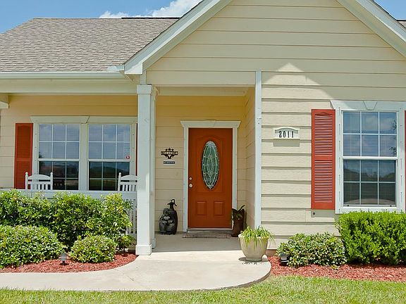 This inviting covered front porch measuring approximately 16' x 8' includes white painted railing an