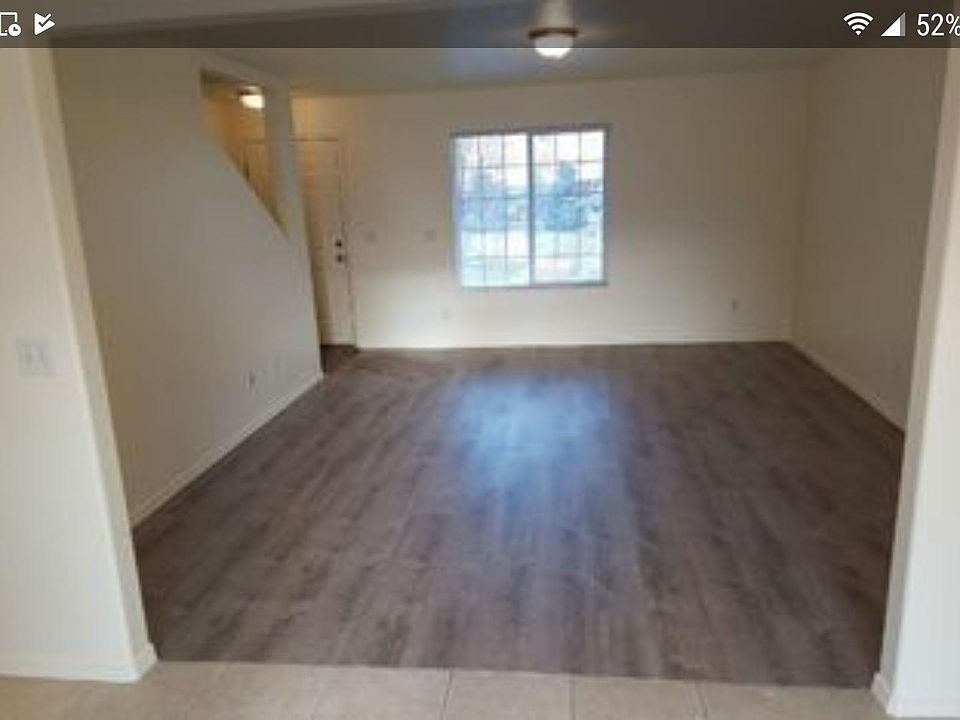 Large living room with beautiful lamin flooring and picture window to front yard
