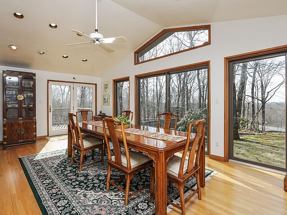 large dining room with walls of windows, doors to