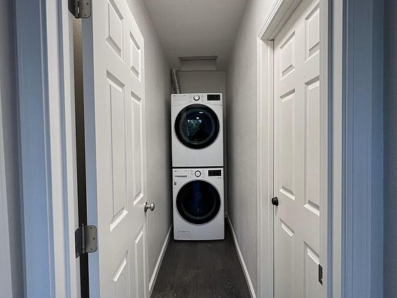 entry hall to kitchen, basement, and smaller bedroom