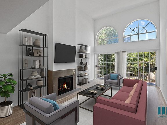 Living Room with Lots of Large-Size Windows, Electric Fireplace, and Vinyl Flooring
