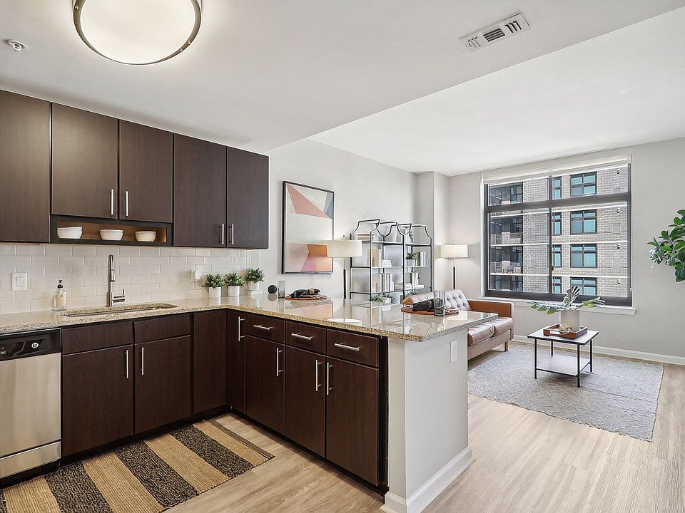 an open kitchen and living room with a large window