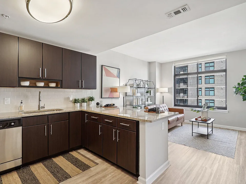 an open kitchen and living room with a large window