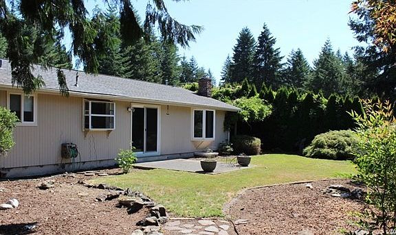 Back view of home.  There is a garden window above the kitchen sink and a bay window in the family room.All windows are vinyl.  Sliders off the dining area open to patio and rear yard.
