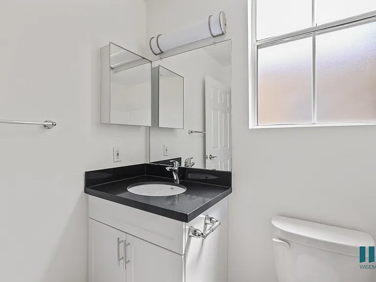 Bathroom with Windows and Vanity Cabinet Storage