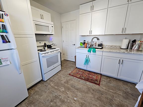 Washer/dryer is located behind the door in the photo.