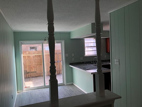 Living room - view into breakfast area, kitchen, and yard