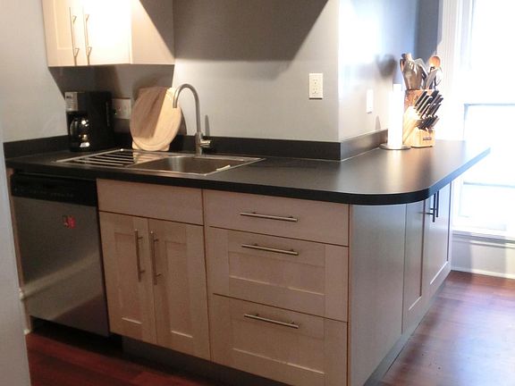 Modern kitchen with dishwasher, drainboard sink and breakfast bar.