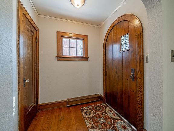 Love the arched wooden front door