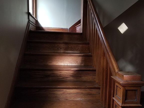 Staircase to upstairs - Both bedrooms & full bath -- just inside front door in Living room.