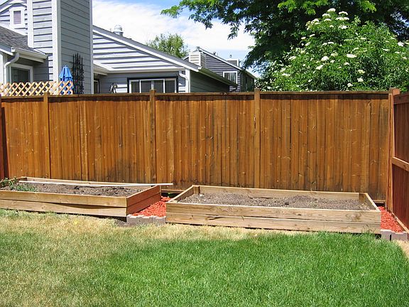 Raised garden area. Yard has sprinkler system. Wooden privacy fence