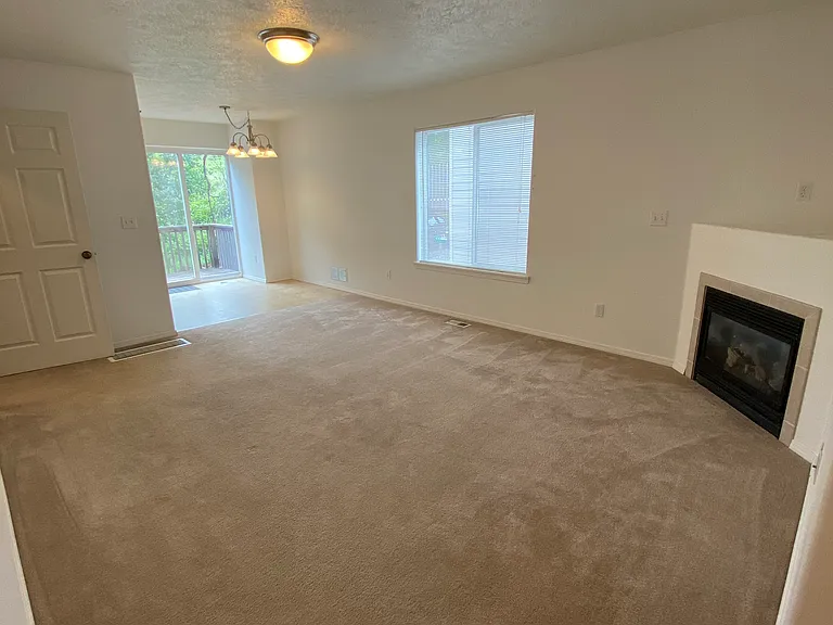 Living room looking into dining area and sliders to back deck.