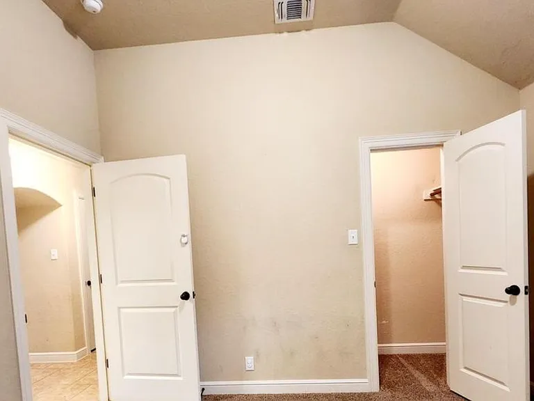 Same bedroom showing the closet and doorway