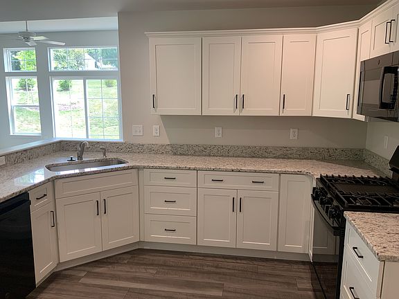 10'9" x 11'5" Kitchen with granite countertops and gas stove. Matching dishwasher and refrigerator will be provided.