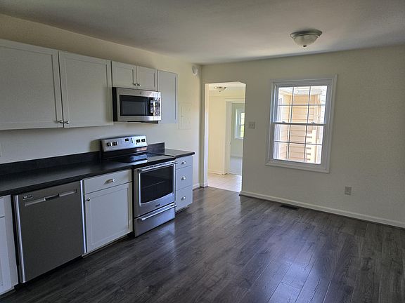 Freshly painted and fully equipped kitchen with stainless steel appliances.