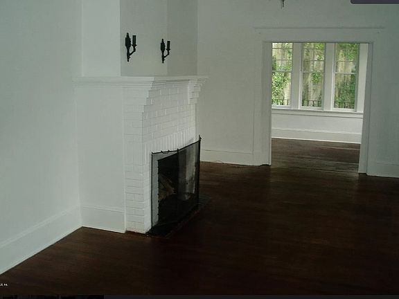 Living room with entrance to sunroom.