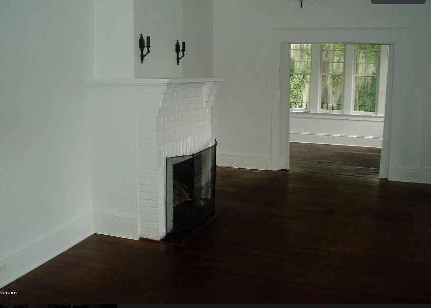 Living room with entrance to sunroom.