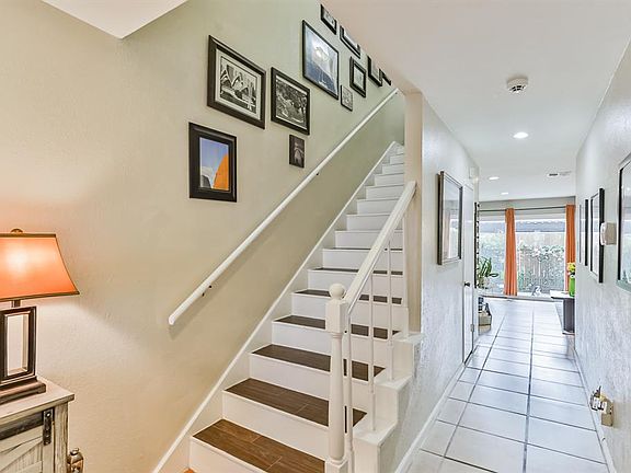 View as you enter the home looking toward the family room. Out of view is the terracotta tile in the entry leading to the ceramic tile. To the right (out of view), through a pocket door, is the entry to bedroom 4/flex room.