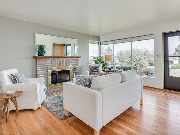 Top to bottom redo includes freshly painted interior and refinishing of original oak hardwood flooring throughout. Wall of windows lets in maximum light and views.