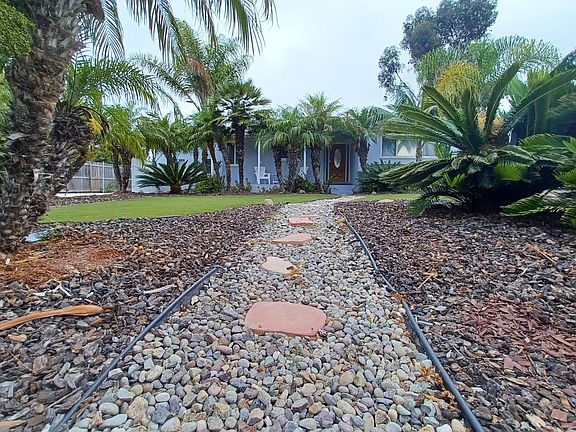 Beachy entrance. Newer concrete driveway along South side