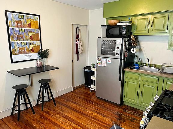Kitchen, gas oven range and door to basement for laundry