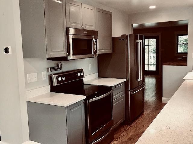 Kitchen with appliances. Note the pot filler over the range.