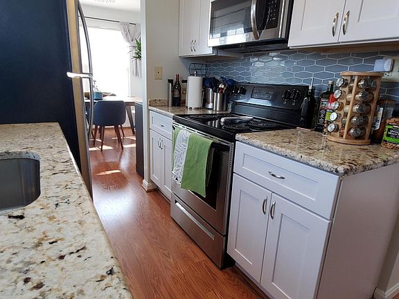 New kitchen with granite and stainless, beautiful backsplash.