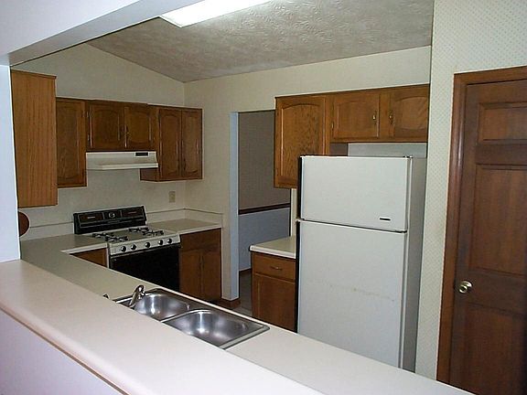 Galley style kitchen has lots of cabinets, a pantry, and is open to the Family Rm.