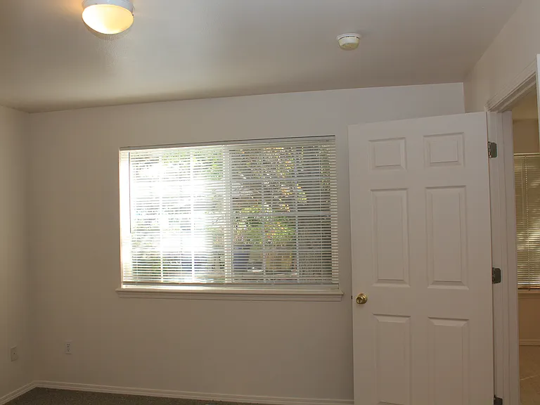 Master Bedroom with View of Beautiful Flowers & Trees on Community Patio.