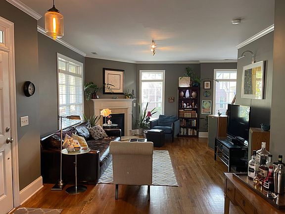 View of living room and entrance. Living room features gas fireplace.