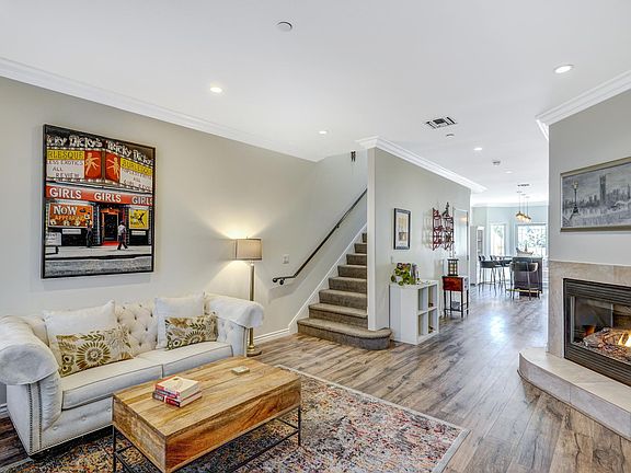 Bright and spacious living room with gas fireplace and large TV