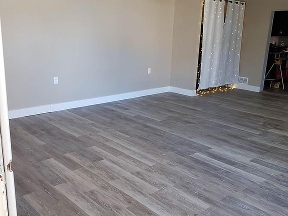 Living Room as you enter in front door. Extra storage closet is behind curtain. Unfurnished view