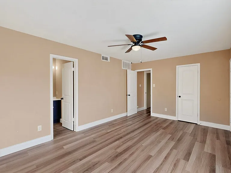 Unfurnished bedroom with light wood-style floors and a ceiling fan