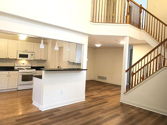 Eat-in-kitchen next to Family room with Cathedral ceiling