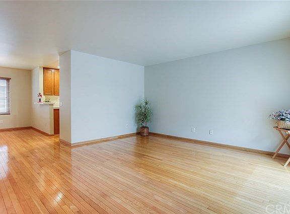 View of living room in front and dining room and kitchen in the background