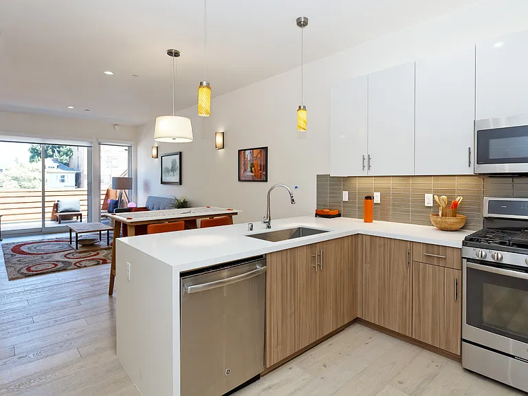 Kitchen with view of living area

(Image shown is a model unit photo. Available units may vary slightly in appearance.)