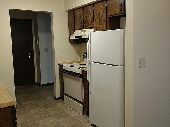 Kitchen with stove and refrigerator