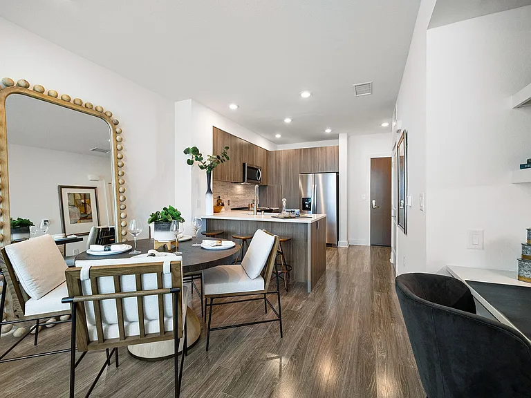 Dining nook with mirror and cozy seating beside kitchen