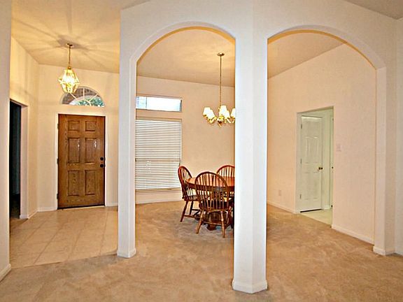 STEP INSIDE TO THE INVITING ENTRY ILLUMINATED BY A LOVELY CHANDELIER
