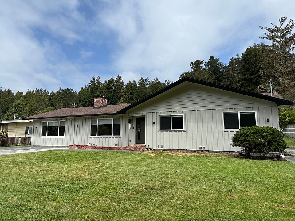 Front of house with yard and driveway.
