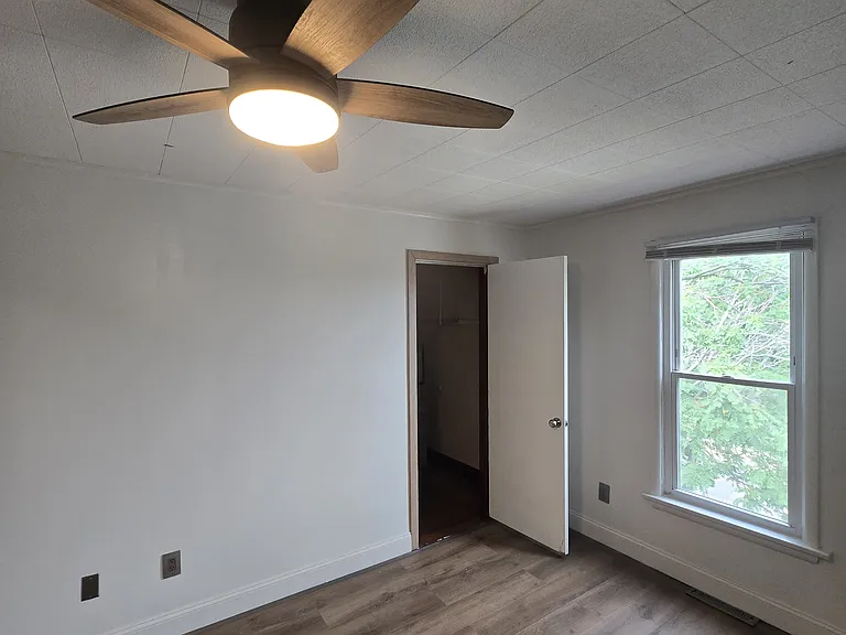 The living room also has a walk-in storage closet large enough for jackets, shoe racks, and an assortment of personal supplies.